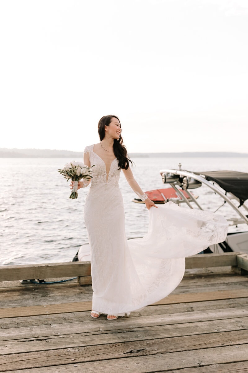 A bride having a moment to herself on the dock at Woodmark Hotel on the Kirkland waterfront. 
