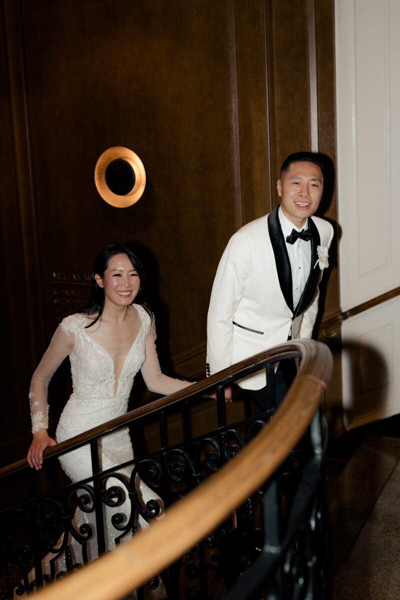 A wedding couple walking up the stairs at Fairmont Olympic wedding.