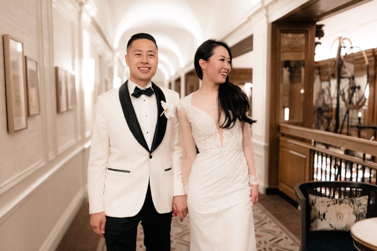 A wedding couple walking down the hall at a Fairmont Olympic wedding.