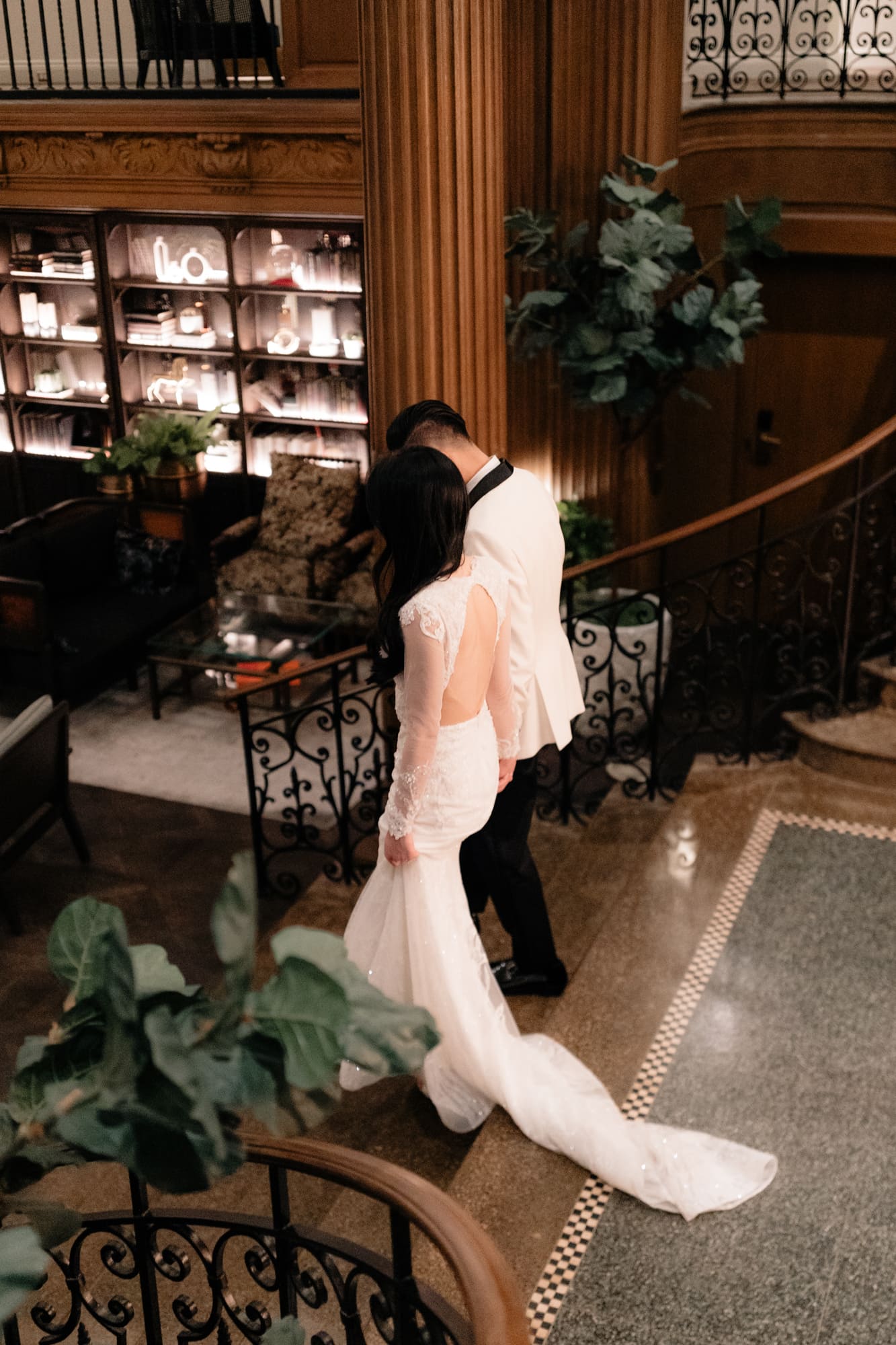 A wedding couple walking through Olympic Bar at Fairmont Olympic Hotel in Seattle.