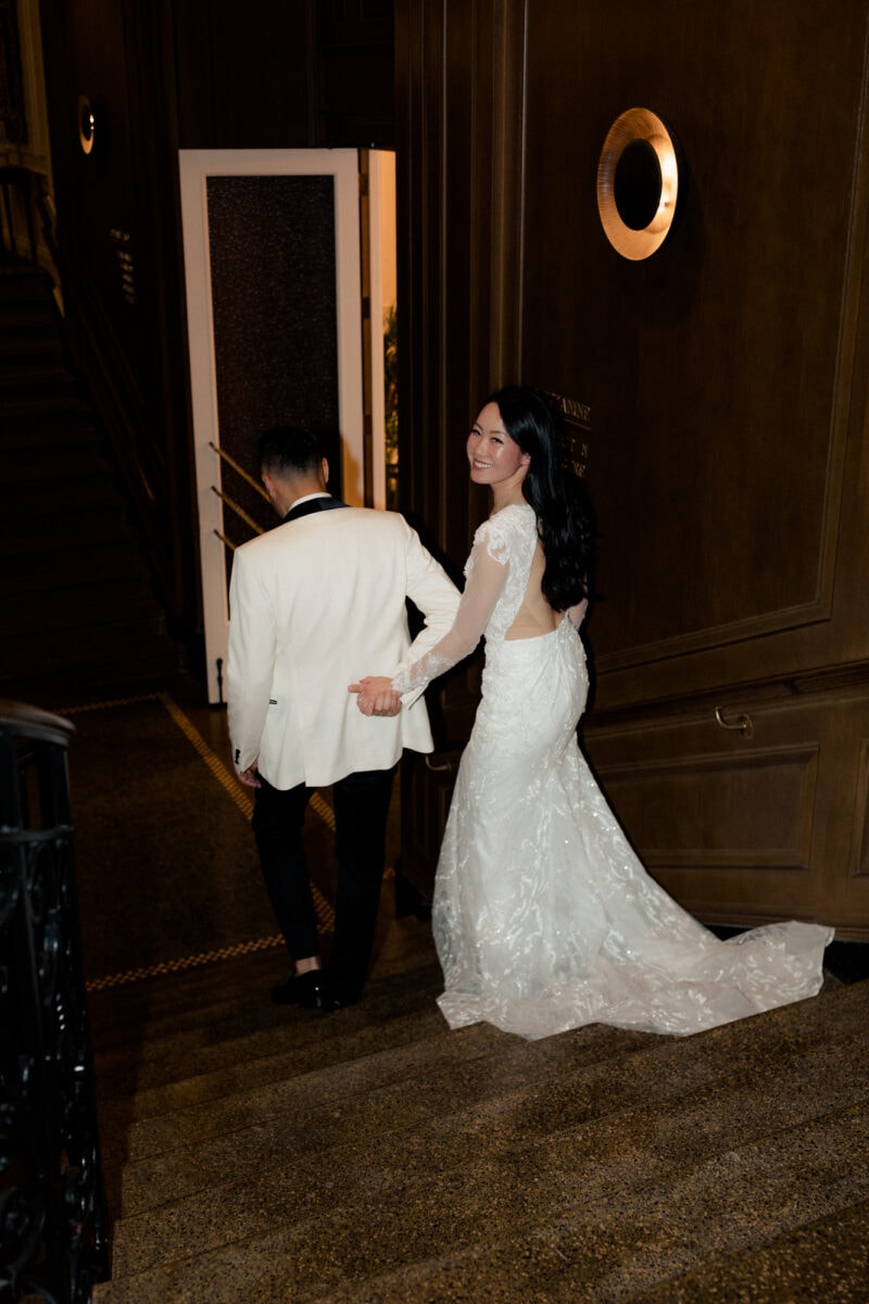 A wedding couple walking down the stairs at a Fairmont Olympic wedding.