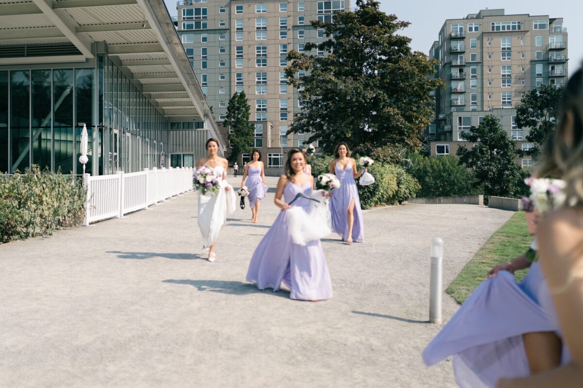 A bride walking briskly with her bridesmaids getting ready for bridal party photos at Olympic Sculpture Park in Seattle.