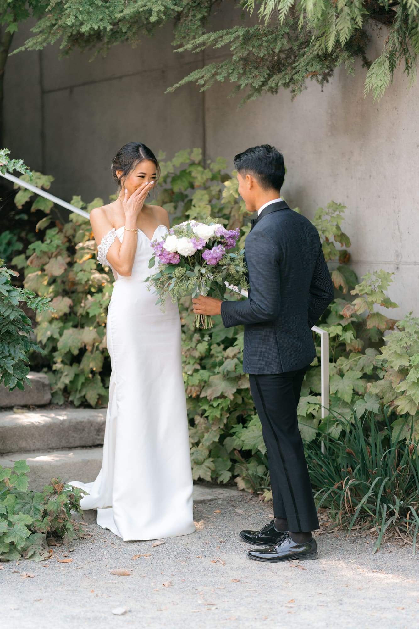 A bride wiping her tears when doing the first look with the groom at Olympic Sculpture Park in Seattle.